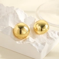 Macro detail of polished gold sphere earrings on a minimalist white artistic display stand - Gold Large Sphere / Gold