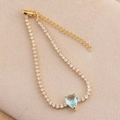 Detail of gold tennis bracelet with teardrop blue stone and micro-pave white zircons - Light Blue