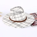 White and black checkered cowboy straw hat with brown braided rope for sun protection - Checkered / White