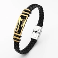 Detail of black woven leather bracelet with golden axe motif clasp and silver buckle - Axe