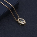 Close-up of gold necklace featuring a green marquise stone and tiny zircons - Light Green