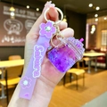 Close-up of a lilac cherry blossom keychain with sakura strap and dried flower petals - Cherry Blossom Rope [purple] Glow-in-the-dark Dried Flower Iceberg Cup