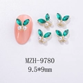 Detailed view of green butterfly nail charms with rhinestones and pearls on pink nail tip - Green Pearl Gold Base Style (MZH-9780)