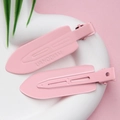 Close-up of pink non-marking hair clips with brand engraving on white heart plate - Light Pink - Glossy with Letters