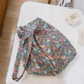Detailed flat lay of floral canvas bag with vintage orange and blue flower patterns - Green Purple Floral