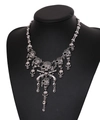 Close-up of gothic skull and pistol pendants on silver metallic tassel necklace - Antique Silver