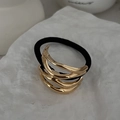 Golden wavy geometric alloy hair cuff with black elastic tie on a textured white stone base - 00618-Wave Layers-Gold