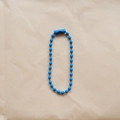 Detailed view of a 2.4mm blue coated metal bead chain with connector on craft paper - Sapphire Blue
