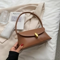 Retro brown leather underarm bag with a gold oval clasp for a vintage minimalist look - Brown