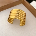 Macro detail of wide gold multi-layer textured cuff bracelet with polished finish - Gold Multi-layer Ribbed