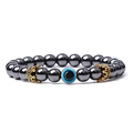 Detailed macro view of hematite beaded bracelet with evil eye and gold crown charms - Hematite (14)
