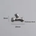 Detailed view of bone-shaped stainless steel pendant with dimensions 20mm x 8mm x 4mm - Bone Shape Charm (P00063S)