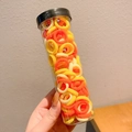 Warm brown-toned cartoon hair ties in a transparent tube container held by hand - 100 Pcs Jar / 9# Yellow 100 Pieces Can