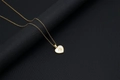 Close-up of 18k gold heart pendant featuring a white shell inlay and golden letter B - Shell Heart Letter B (With Chain)