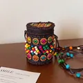 Detailed shot of handmade bohemian coconut shell woven bag with colorful beads and zip - Brown Colorful Cylindrical Style (AQ367)
