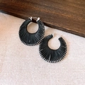 Black fan-shaped woven earrings with silver hoop fasteners on beige fabric surface - Silver Black - Small