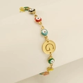 Gold evil eye bracelet with colorful enamel charms and a circular letter G pendant - Letter G