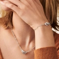 Detail of silver handcuff-style clasp on necklace and bracelet worn by model - Steel Color Bracelet + Necklace