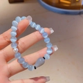 Close-up of cat eye beaded bracelet with grey teardrop stone and white pearl detail - Cat's Eye Black Agate (Water Drop Pendant)