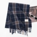 Winter scarf featuring deep blue plaid pattern with decorative fringe and small label - Navy Plaid