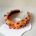 Orange knotted Halloween headband with colorful beads and gemstones on a white tray - H-Orange Pearl Gemstone