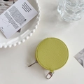 Lime green round leather coin purse with silver zipper and lychee grain texture close-up - Matcha Green