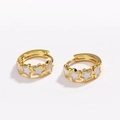 Detail of gold hoop earrings featuring white enamel stars on a clean white background - Pentagram White
