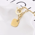 Gold hip hop heart pendant necklace with Roman numeral toggle clasp on white background - Bracelet / Gold