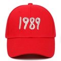 Detail of red cotton baseball cap featuring white 3D embroidered 1989 text on front - Red