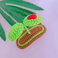Handmade crochet green sprout hair clip with a tiny red ladybug on brown base - Round Leaf with Ladybug