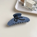 Denim blue acetate hair claw clip featuring a small black rhinestone bow on white surface - Light Denim Bowknot