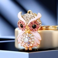 Golden owl keychain with colorful crystals and pink rhinestones on a metal base - A430 Owl O Pink