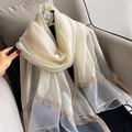 Close-up of white and grey silk shawl featuring elegant gold trim and delicate beads - 195CM / White