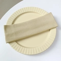 Close-up of beige ribbed knit headband on a decorative plate with soft natural light - Beige