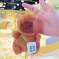 Brown capybara plush keychain with small white crossbody bag and green fortune character - Dark Brown Green Fortune + Bead Chain