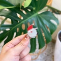 Mini acrylic Santa Claus hair clip with glitter finish held in hand for size display - Santa Claus