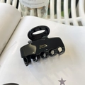 Detailed close-up of a medium black acetate hair claw clip with golden text detail - Oval Head Square Claw (Approx 5cm) / Black