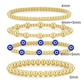 Stack of gold hematite beaded bracelets with 4mm and 5mm beads including evil eye charm - Set 03 Gold (4pcs/Evil Eye)