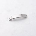 Macro shot of silver stainless steel curved connector with hollow cutout and end holes - Hamsa Hand Steel