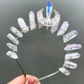 Detail shot of a handmade crystal crown featuring white moon ornament and silver wire wraps - AB White