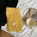 Soft yellow knitted wool blend scarf with ggg label displayed on a cozy white bed - 3g Series / Yellow