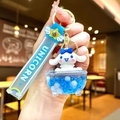 Macro shot of Cinnamoroll keychain showing a blue glitter oil container and silicone strap - Wing Rope [blue] Glow-in-the-dark Bubble Bead Bathtub