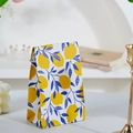 Mini gift paper bag featuring yellow lemon and blue leaf pattern for party favors - Lemon