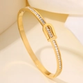 Elegant gold titanium steel bracelet with pavé white zircon stones and LOVE engraving - Gold LOVE Bangle