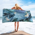 Detail of microfiber beach towel with tropical blue Monstera leaves and Save the date print - Tropical Orchid