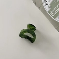 Detailed top view of a dark green acetate hair claw clip on a white minimalist background - Small Size 6