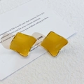 Macro shot of geometric mustard yellow enamel square earrings with gold plated frames - Ginger Yellow