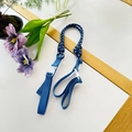 Detailed view of durable blue nylon woven strap with a white plastic buckle for tote bags - Blue Strap