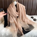Detail showing sheer champagne gold silk scarf texture with elegant gold-bordered edges - Dark Skin Red