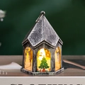 Detail of vintage silver Christmas lantern with warm LED candle on a book prop - Antique Silver - Christmas Tree